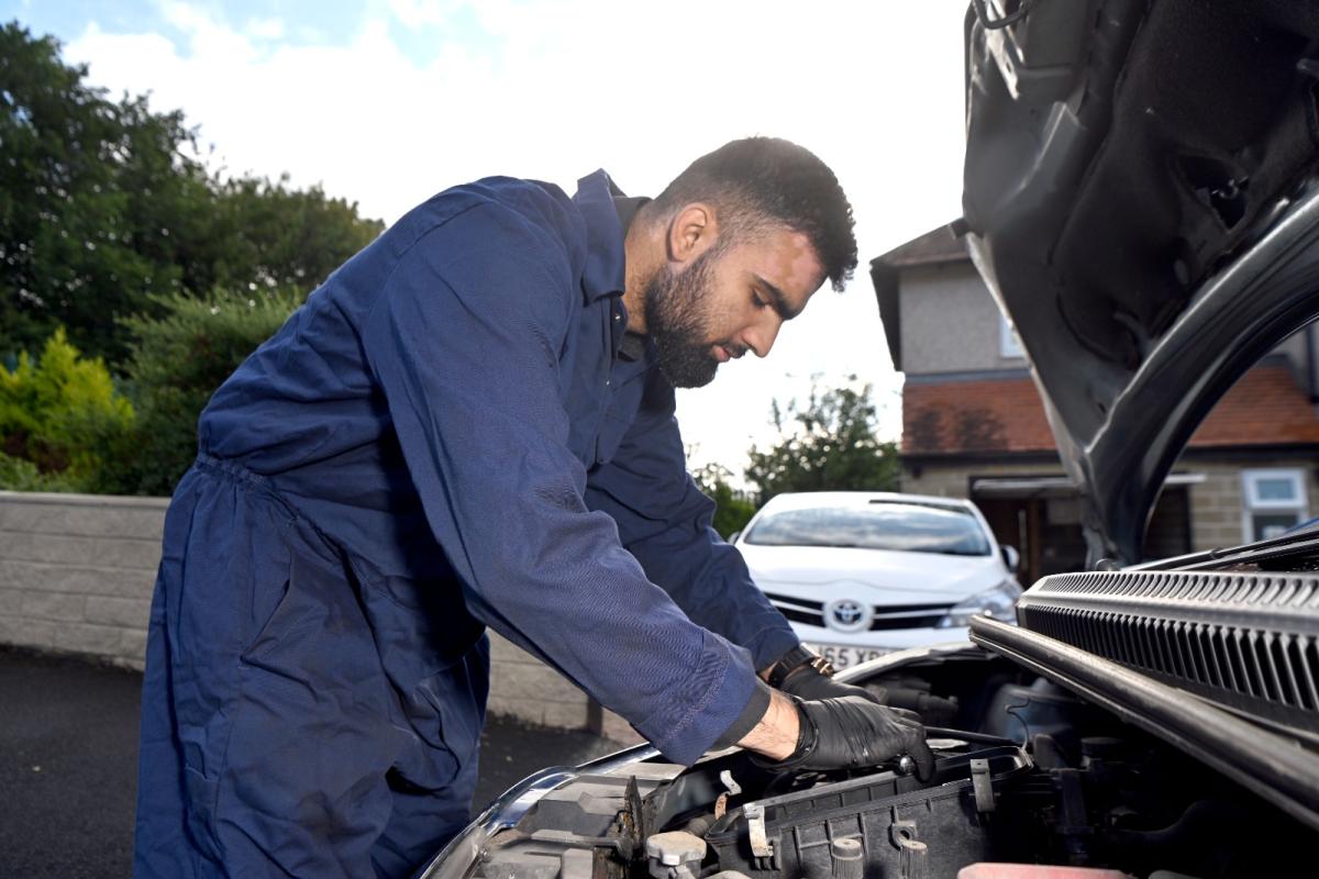 Kamron Ali working on a vehicle